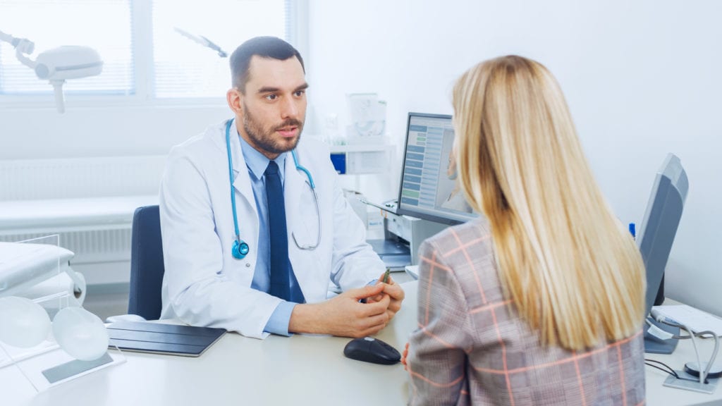 doctor consulting woman at the Dermatologist's office