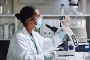 Cropped shot of an attractive young female scientist examining a medical sample inside of a vile while working in her laboratory